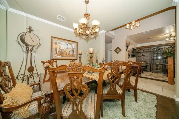 a view of a dining room with furniture and chandelier