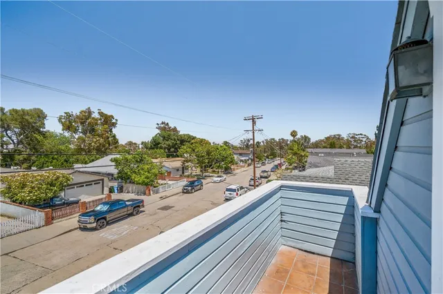 a view of a balcony and cars park