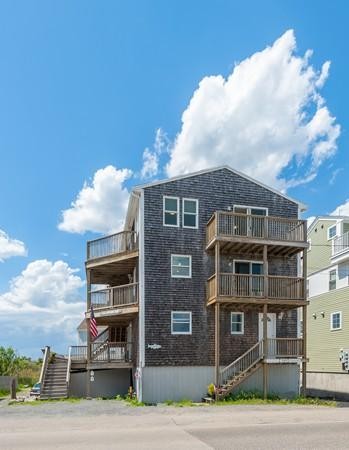 149 Jericho Road, Unit A Scituate, MA 02066 - Photo 3 of 21 a front view of a residential apartment building with a yard