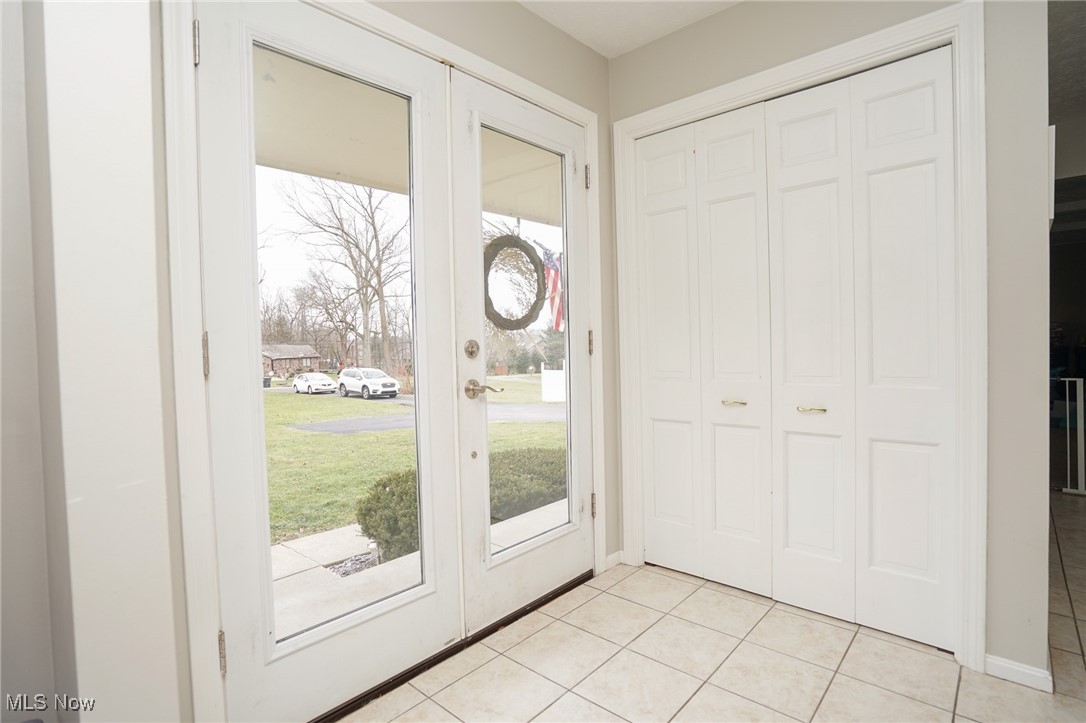 8651 King Graves Road Northeast Warren, OH 44484 - Photo 12 of 24 Entryway featuring french doors and light tile patterned floors