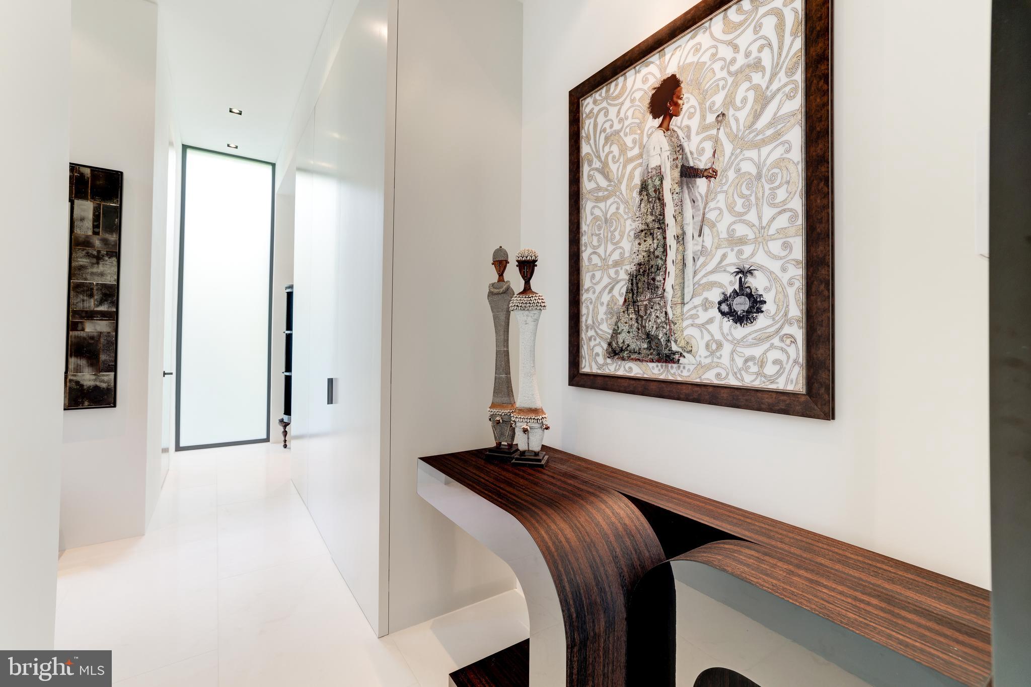 410 Chain Bridge Road McLean, VA 22101 - Photo 16 of 26 a bedroom with a bed and painting on the wall