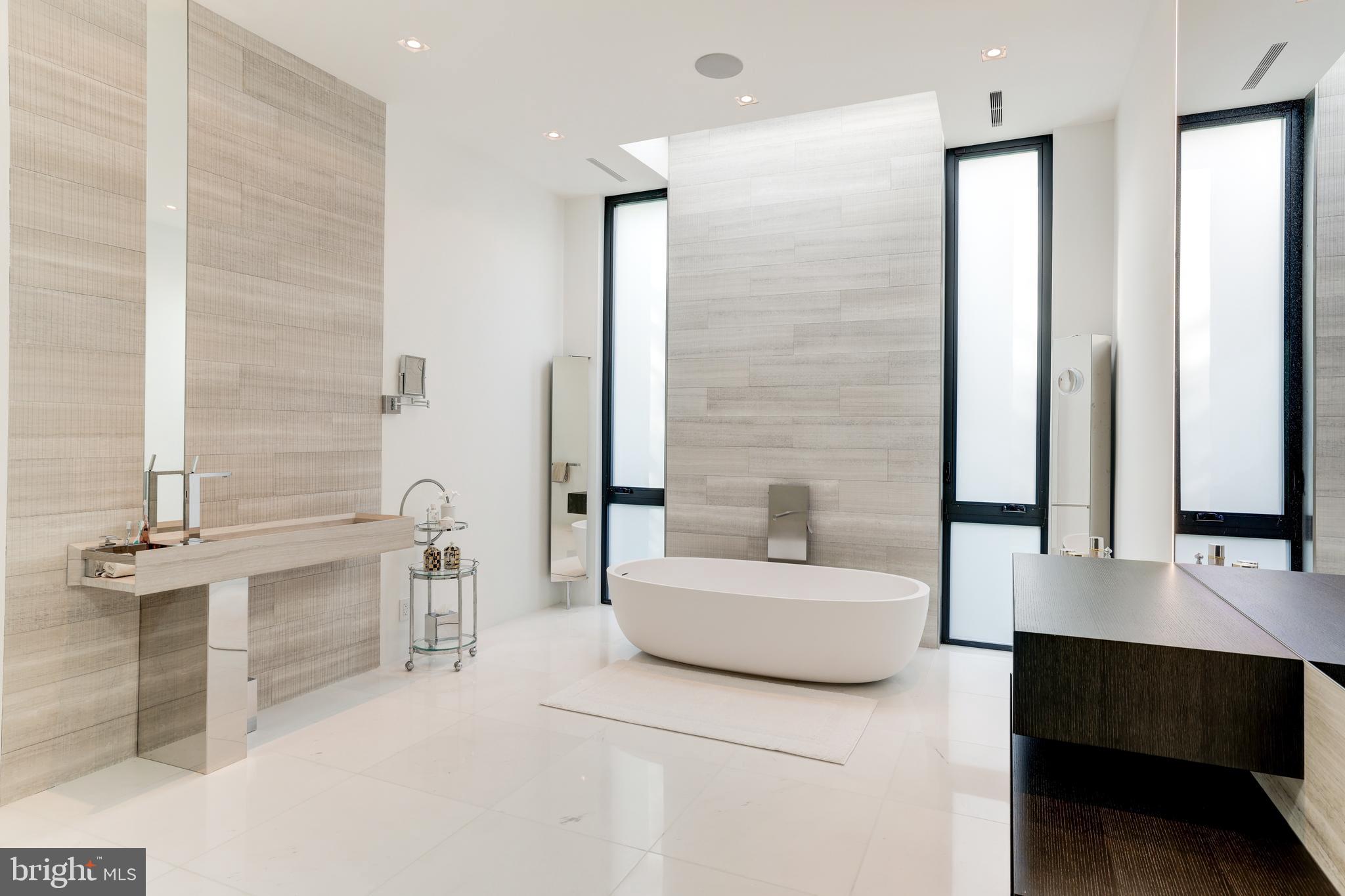410 Chain Bridge Road McLean, VA 22101 - Photo 21 of 26 a bathroom with a double vanity sink a mirror and a bathtub
