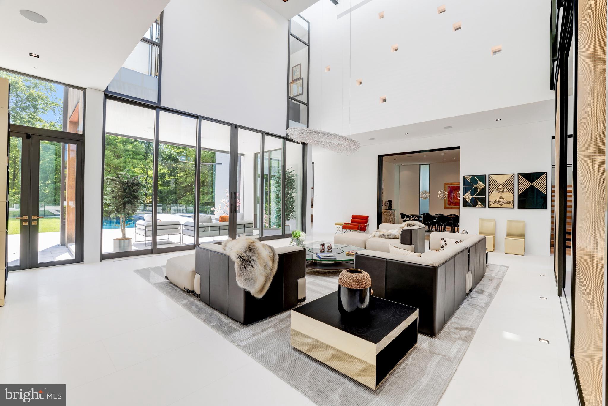 410 Chain Bridge Road McLean, VA 22101 - Photo 8 of 26 a living room with furniture large window and a chandelier