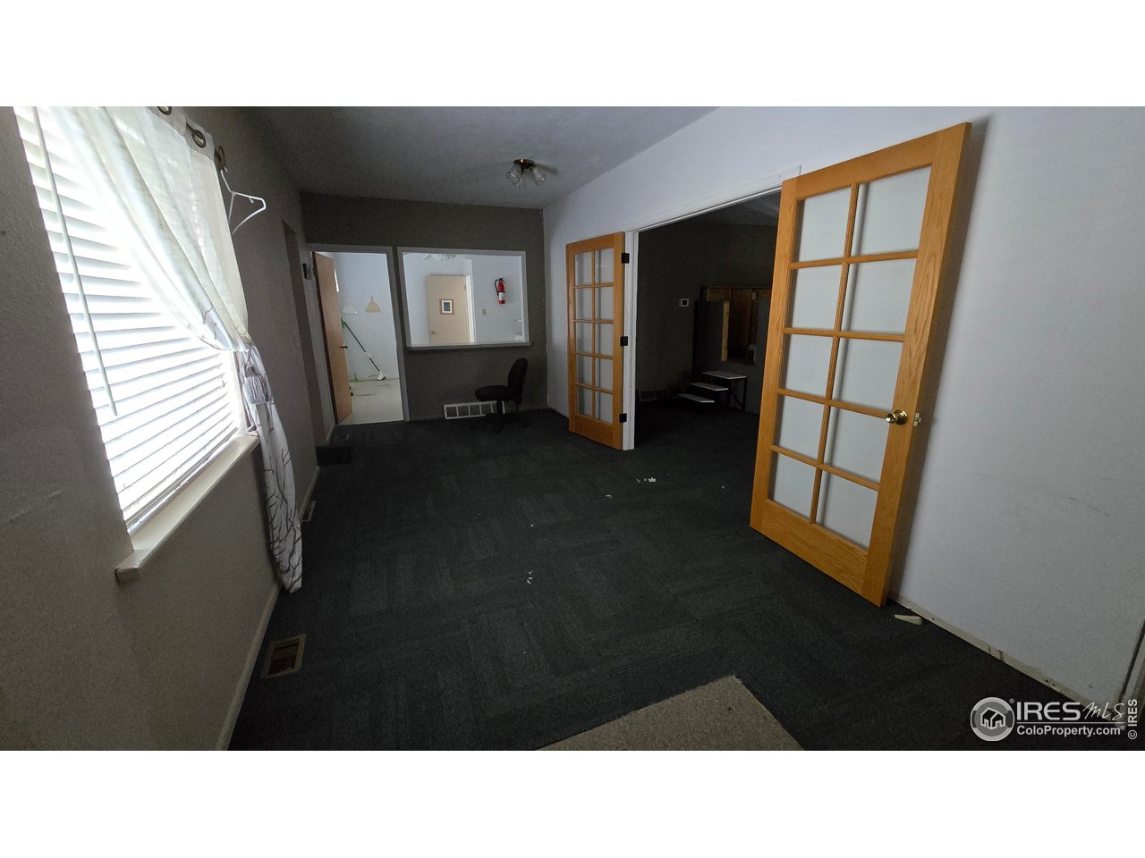 118 Dickson Street Wiggins, CO 80654 - Photo 12 of 34 DOOR TO THE RIGHT GOES INTO THE MAIN AUDITORIUM EXTERIOR BACK DOOR THIS SIDE OF THE KITCHEN AT THE FAR END OF PHOTO