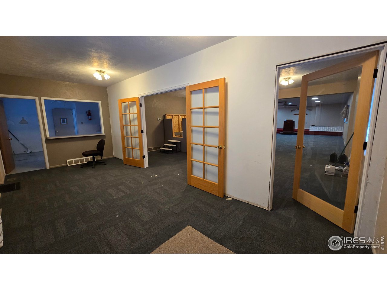 118 Dickson Street Wiggins, CO 80654 - Photo 14 of 34 THE ROOM AT THE BACK OF THE AUDITORIUM WITH THE KITCHEN AT THE LEFT