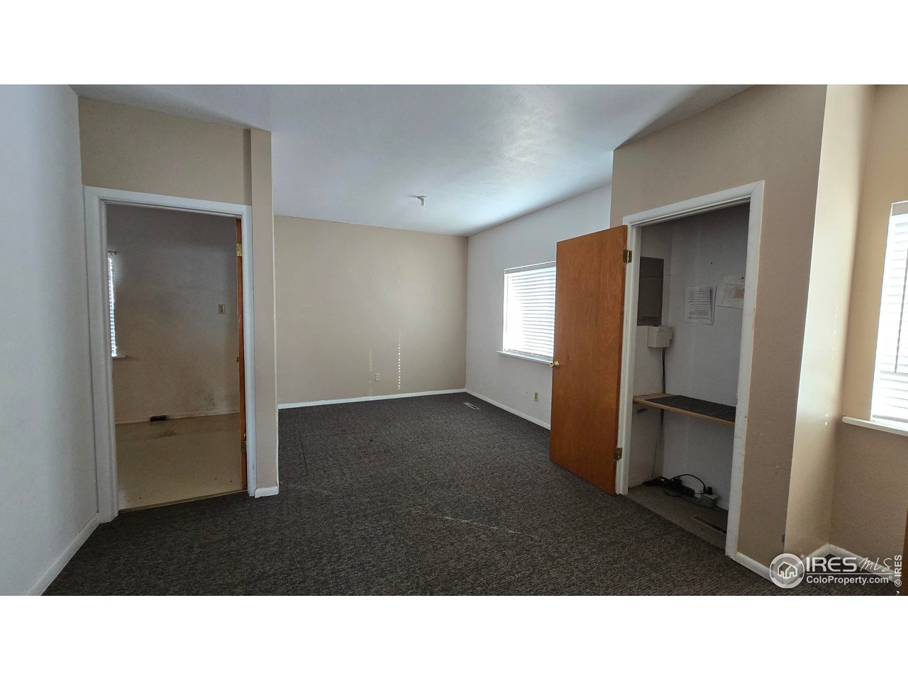 118 Dickson Street Wiggins, CO 80654 - Photo 15 of 34 TAKEN FROM HALL WITH THE HALF BATHS, DOOR AT LEFT GOES INTO KITCHEN, CRAWL SPACE ACCESS IS IN THIS ROOM