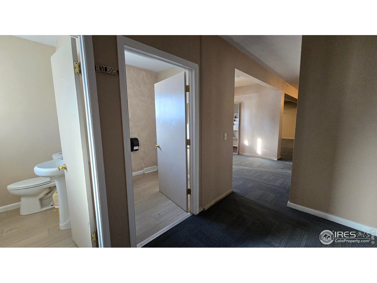 118 Dickson Street Wiggins, CO 80654 - Photo 21 of 34 SHOWS BOTH HALF BATHS FROM THE STORAGE CLOSETS LOOKING TOWARD MAIN ENTRANCE AND THE MAIN AUDITORIUM