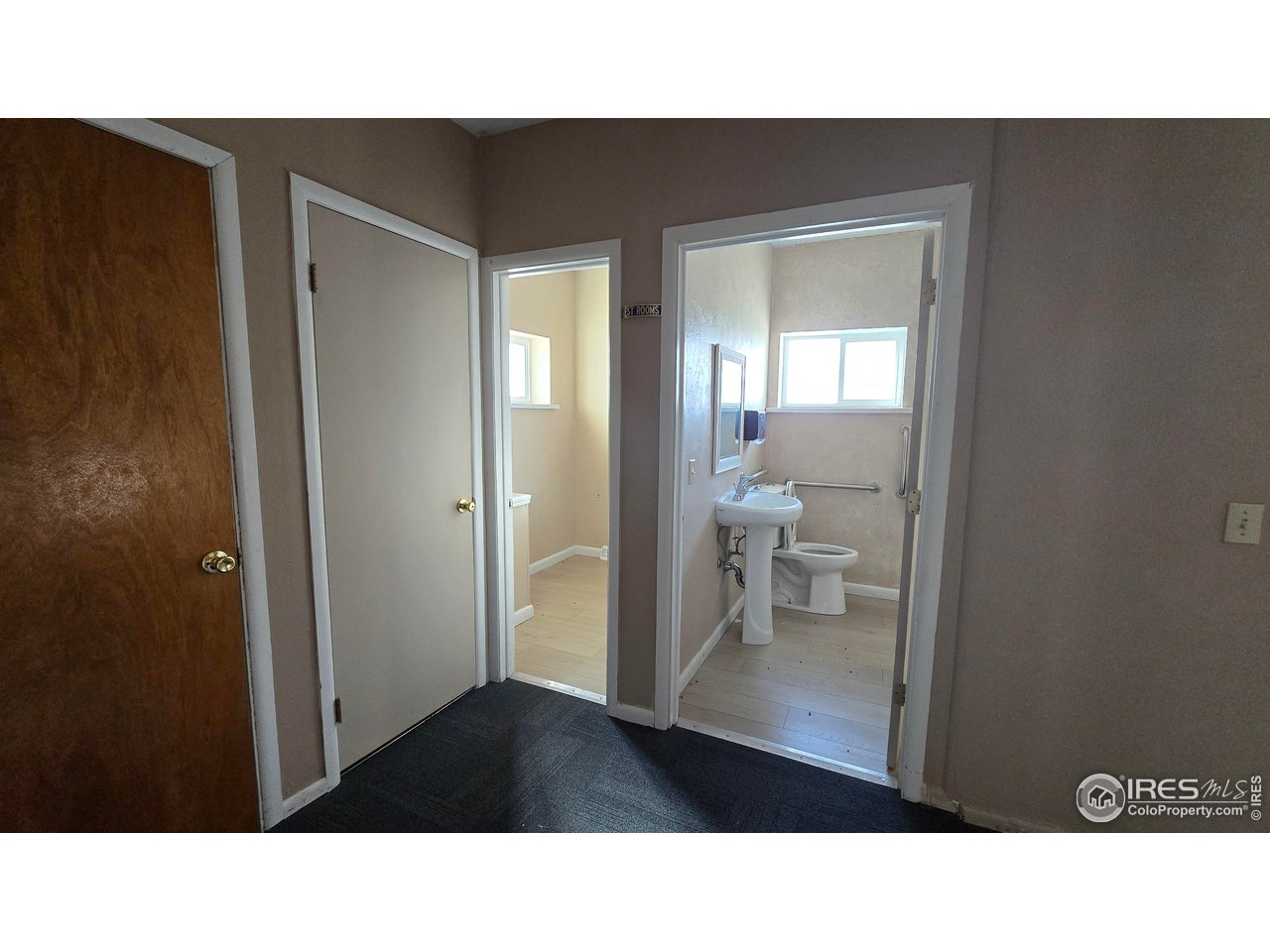 118 Dickson Street Wiggins, CO 80654 - Photo 22 of 34 THE 2 HALF BATHS IN THE HALLWAY WITH STORAGE CLOSETS ON THE LEFT