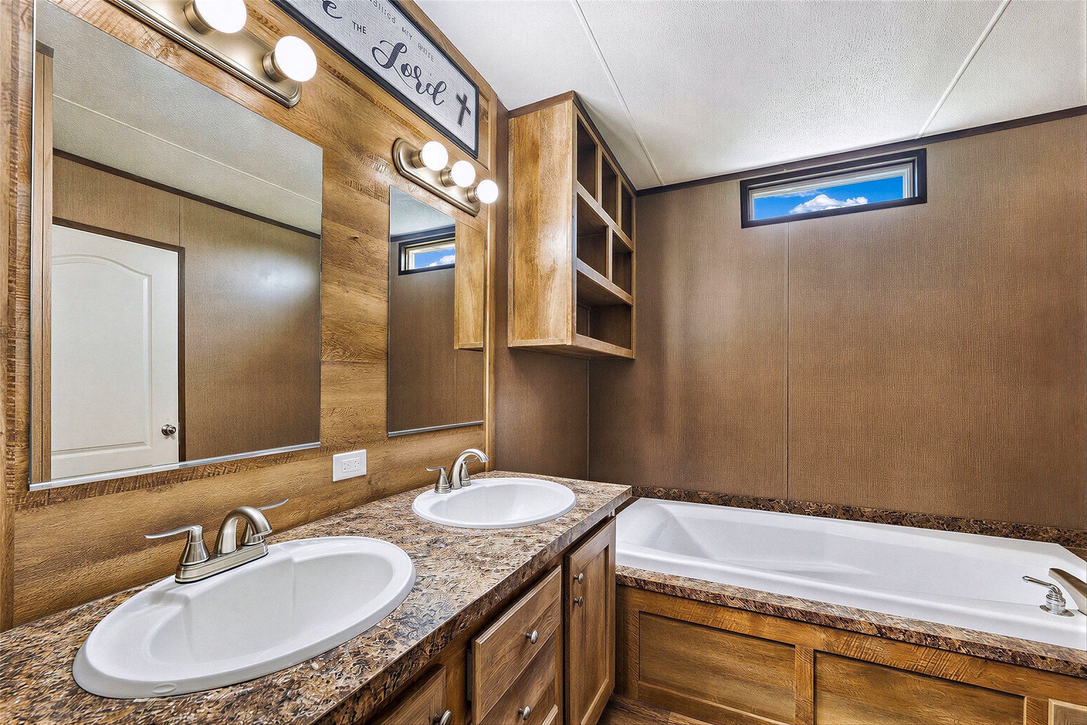 935 Lower Red Rock Road Bastrop, TX 78602 - Photo 20 of 25 Double vanity sinks and a comfortable bathtub create a versatile and functional space.