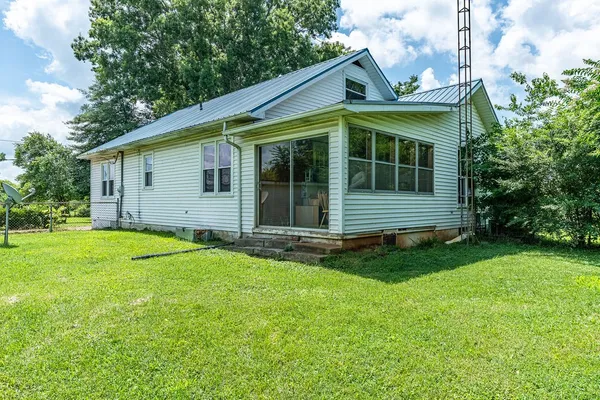 a view of a house with a backyard