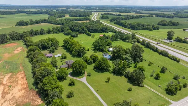 an aerial view of a forest with houses