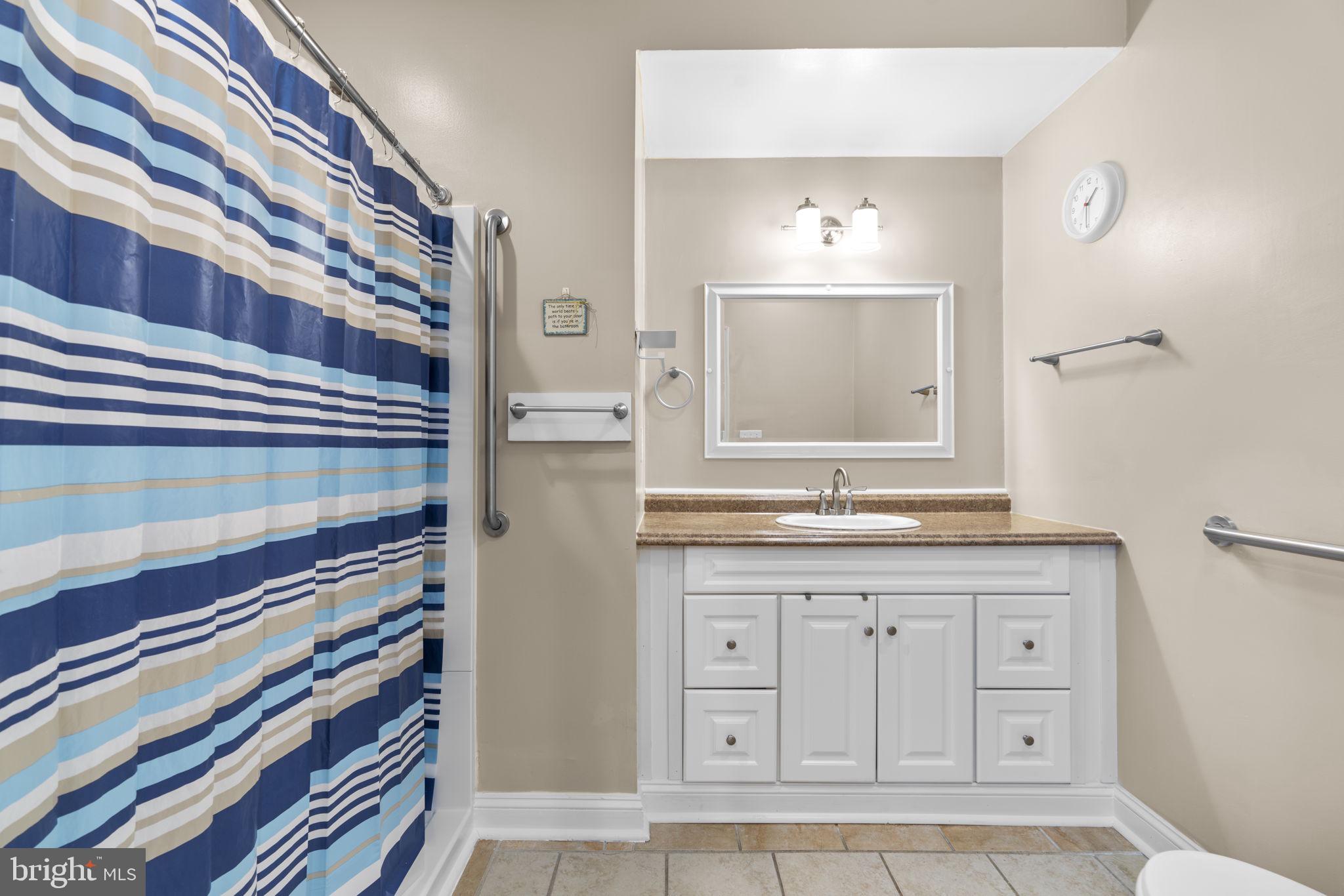 8024 Solley Road Glen Burnie, MD 21060 - Photo 70 of 83 a bathroom with a granite countertop sink a mirror and a