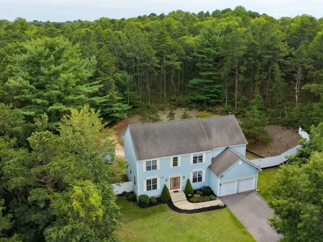 an aerial view of a house with pool table and chairs