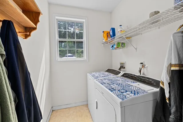 a utility room with dryer and window