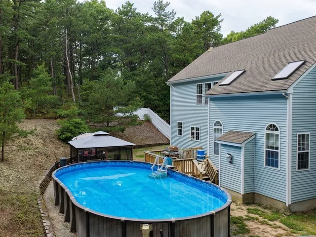 a view of a house with pool and chairs