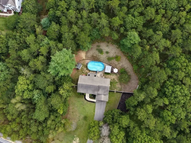 an aerial view of a house with a yard