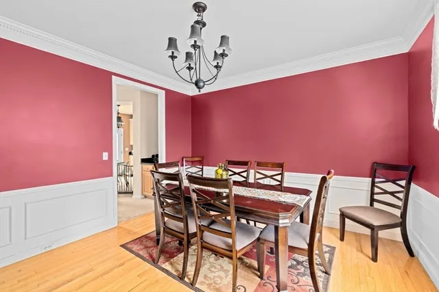 a view of a dining room with furniture and chandelier