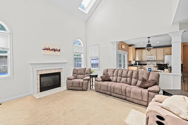 a living room with furniture white walls and a fireplace
