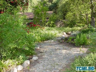 40913 Elk Drive Three Rivers, CA 93271 - Photo 3 of 3 a view of a garden with plants and a bench