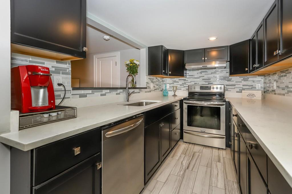 17 Fairview Road Canton, MA 02021 - Photo 31 of 40 a kitchen with stainless steel appliances a stove sink microwave and cabinets
