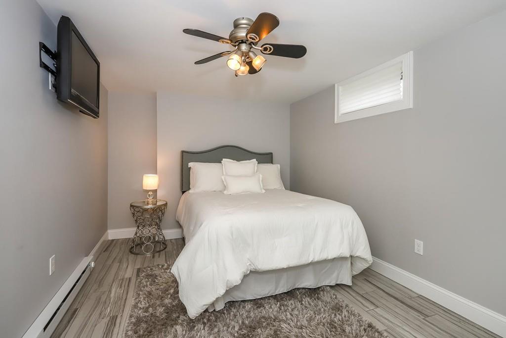 17 Fairview Road Canton, MA 02021 - Photo 32 of 40 a bedroom with a bed and a flat tv screen on dresser