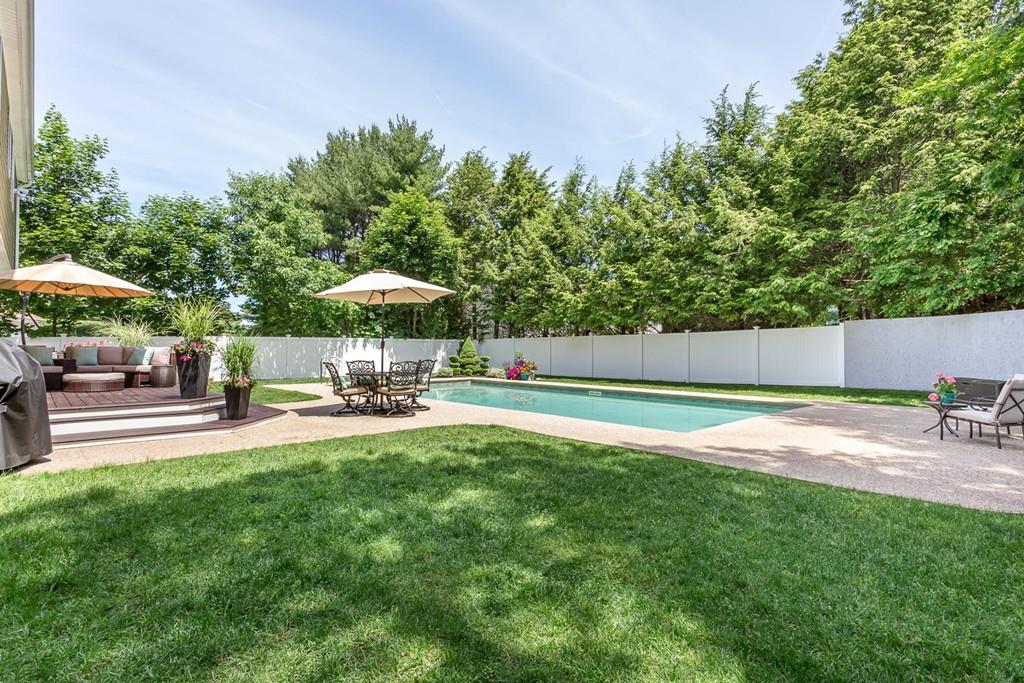 17 Fairview Road Canton, MA 02021 - Photo 38 of 40 a view of a swimming pool with a table and chairs under an umbrella