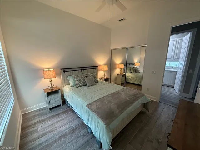 a bedroom with a bed and wooden floor