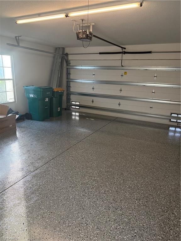 7549 Garibaldi Court Naples, FL 34114 - Photo 14 of 15 Garage featuring a garage door opener