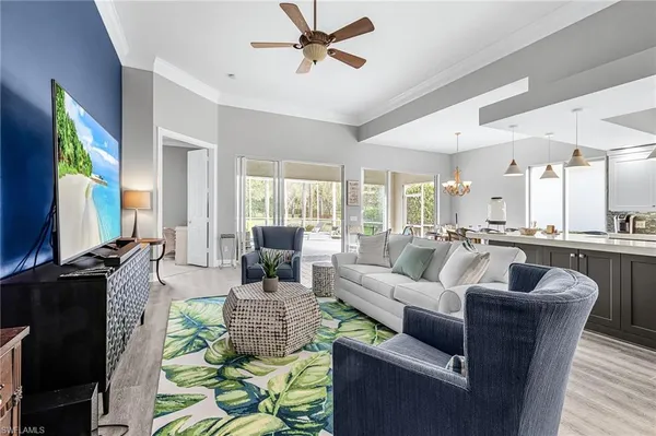a living room with furniture wooden floor and a flat screen tv