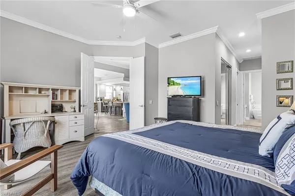 a spacious bedroom with a bed and a view of living room