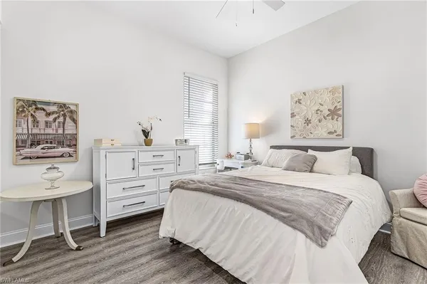 a bedroom with a bed and a chair