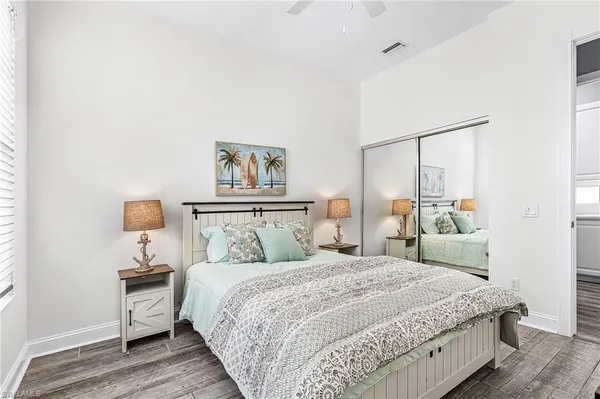 a bedroom with a bed and a night stand