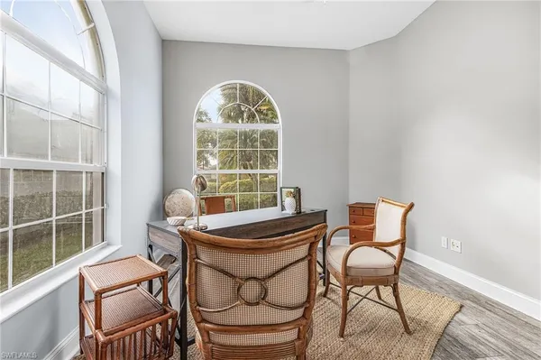 a dining room with furniture a rug and wooden floor