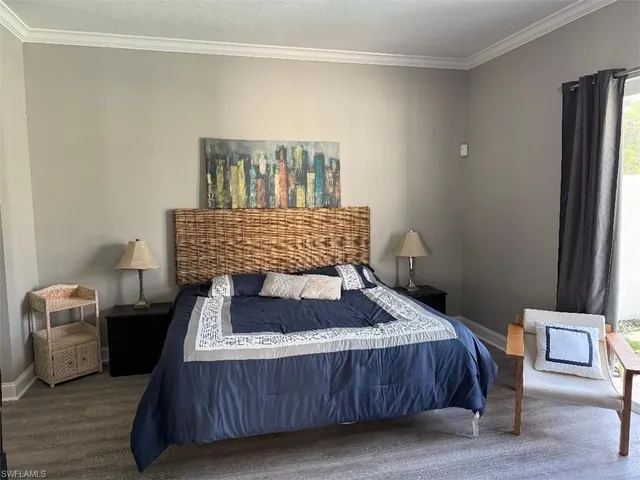 a bedroom with a bed and a night stand