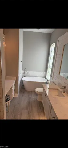 a bathroom with a sink a toilet and a bathtub
