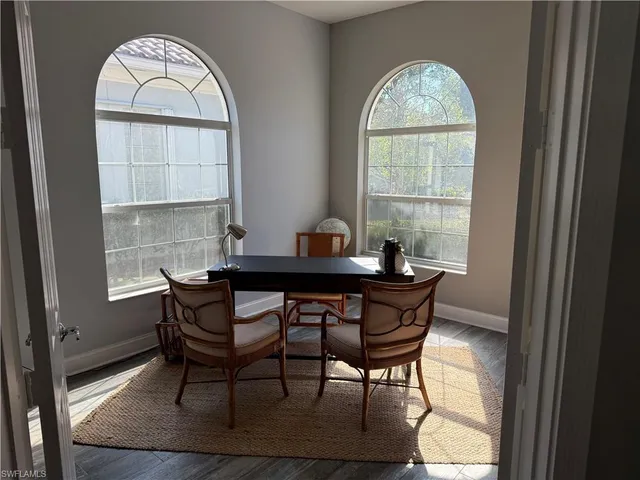 a dining room with furniture a rug and a window