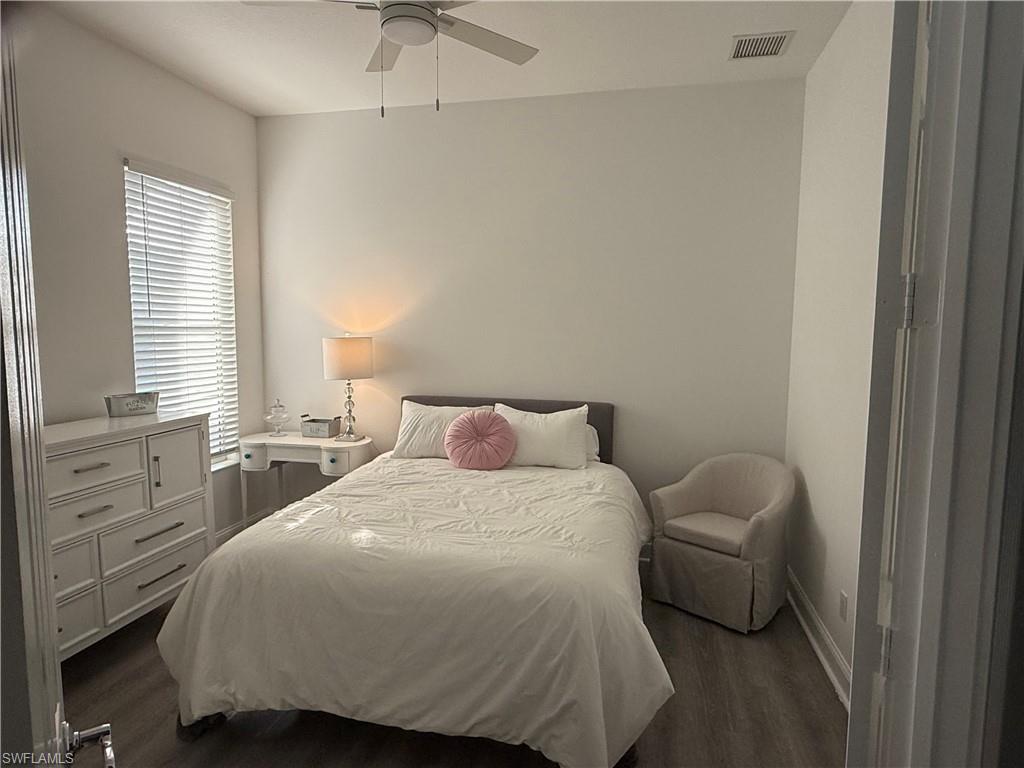 7549 Garibaldi Court Naples, FL 34114 - Photo 10 of 15 Bedroom with dark wood-style floors and ceiling fan