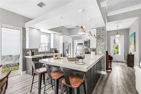 a large kitchen with a large window and stainless steel appliances