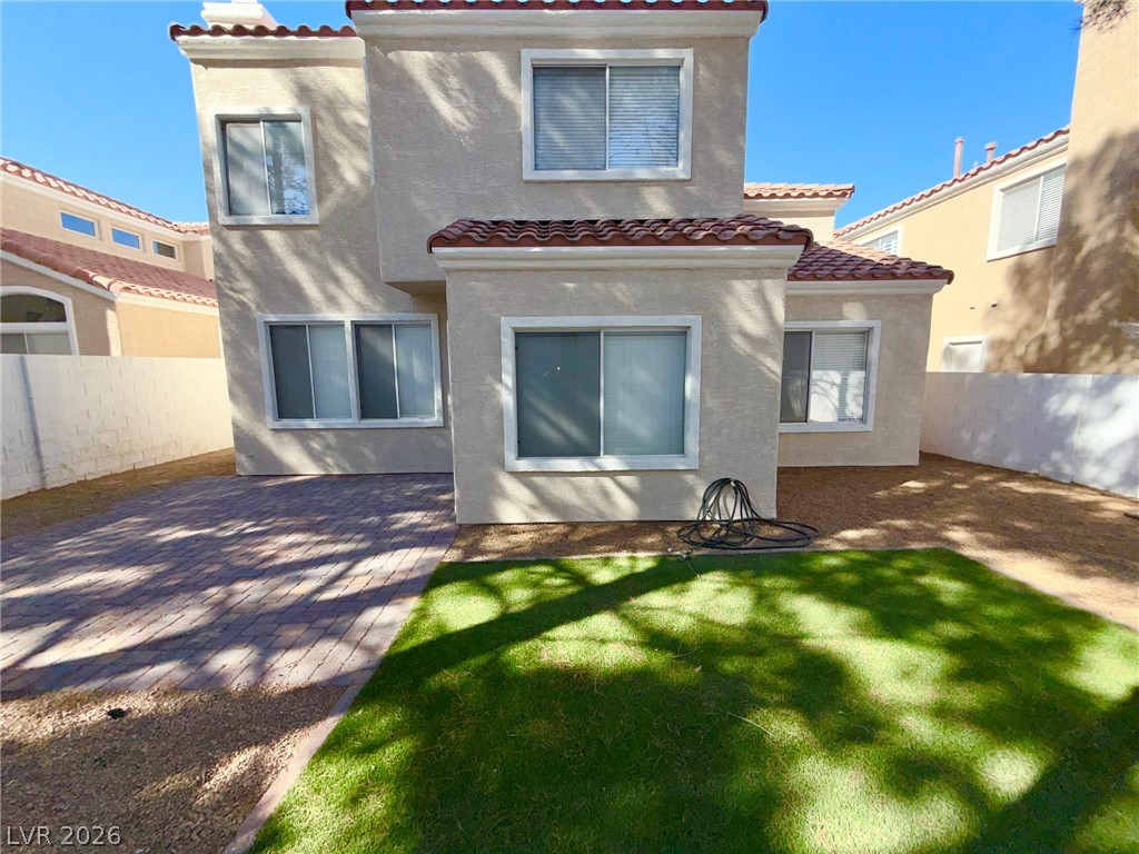 9729 Trail Rider Drive Las Vegas, NV 89117 - Photo 25 of 26 A private yard with a paver patio and fresh green lawn awaits outdoor enjoyment.