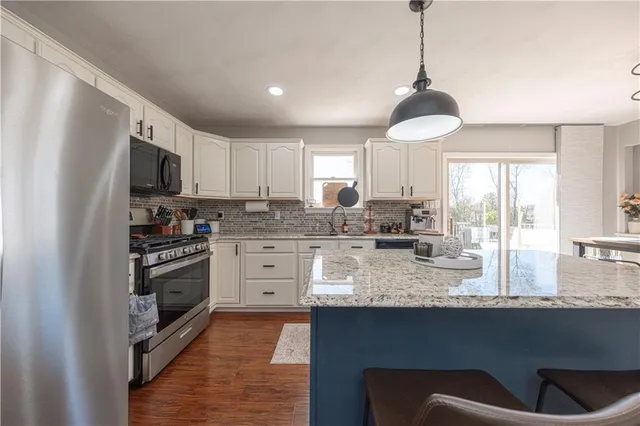 a kitchen with sink cabinets and window