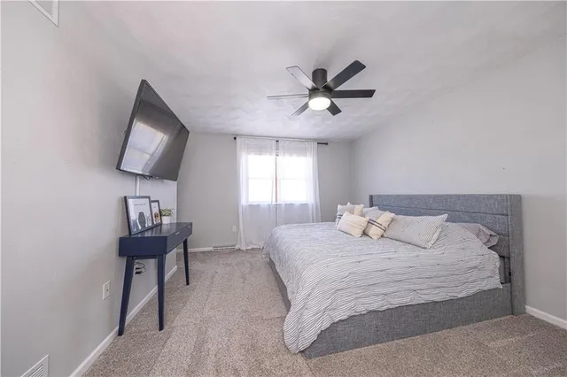 a bedroom with a bed and a chair