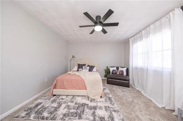 a bedroom with a bed and window