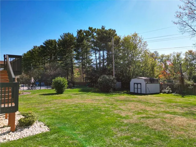 a view of a house with a yard and deck