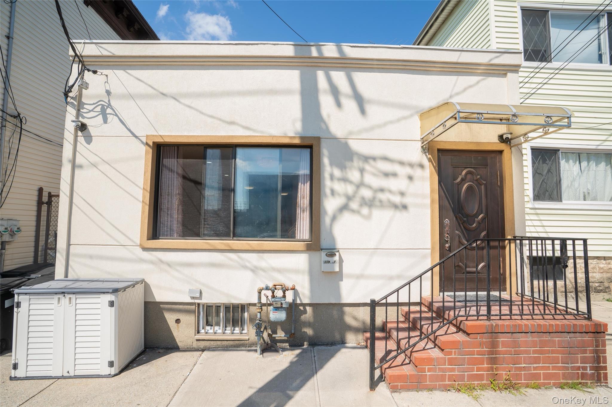 a view of a brick house with iron stairs