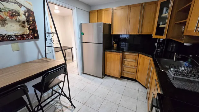 a kitchen with stainless steel appliances granite countertop a refrigerator and a stove top oven