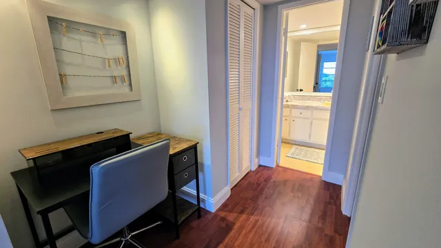 a room with wooden floor and windows