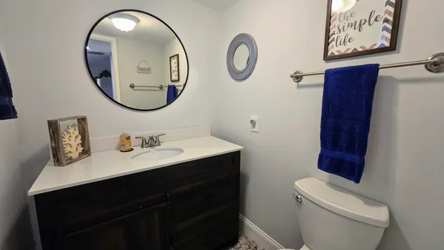 a bathroom with a toilet a sink and a mirror