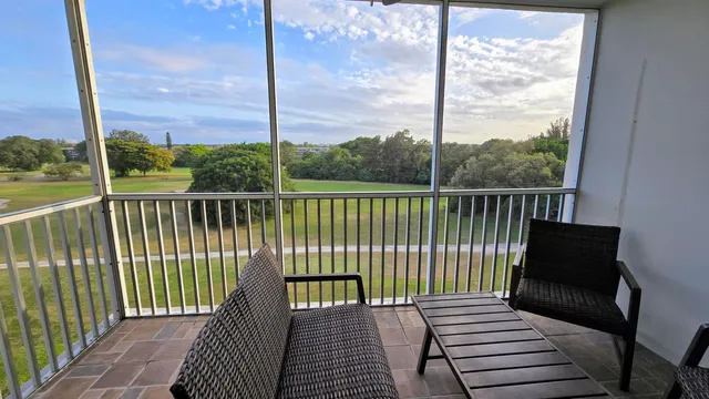 a view of a balcony with wooden floor