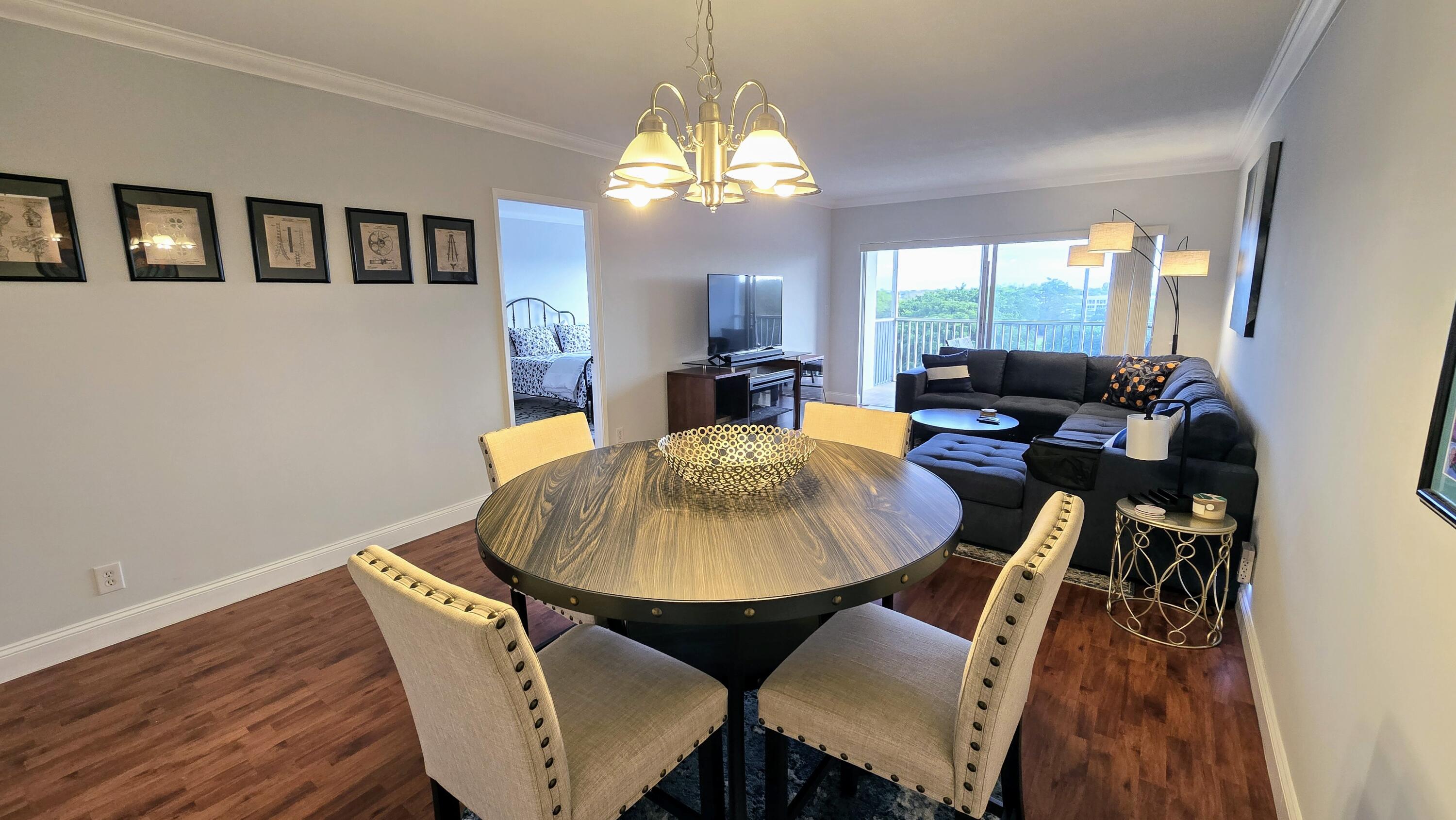 3100 North Palm Aire Drive, Unit 604 Pompano Beach, FL 33069 - Photo 8 of 25 a view of a dining room with furniture window and wooden floor