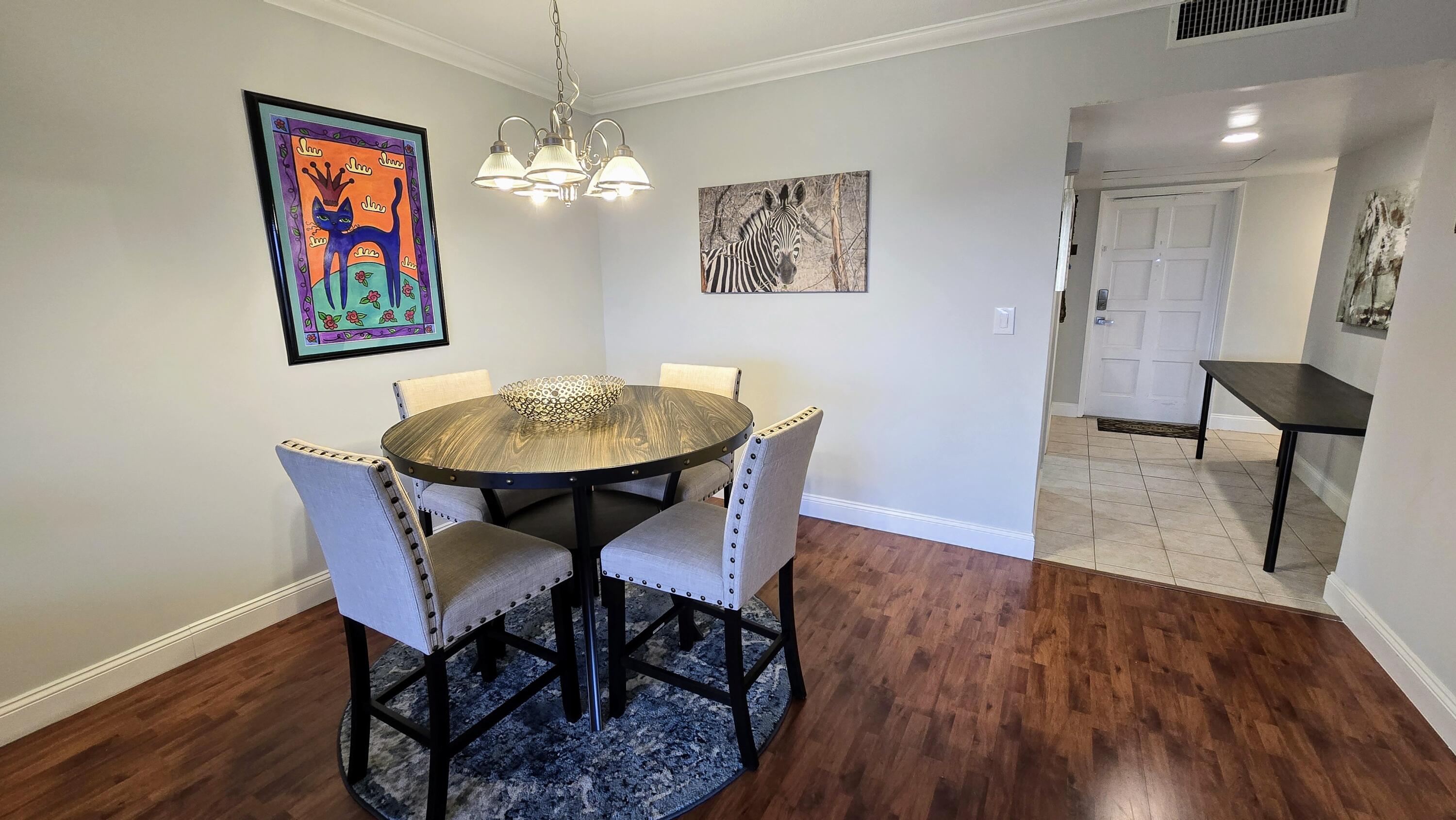 3100 North Palm Aire Drive, Unit 604 Pompano Beach, FL 33069 - Photo 9 of 25 a view of a dining room with furniture and wooden floor